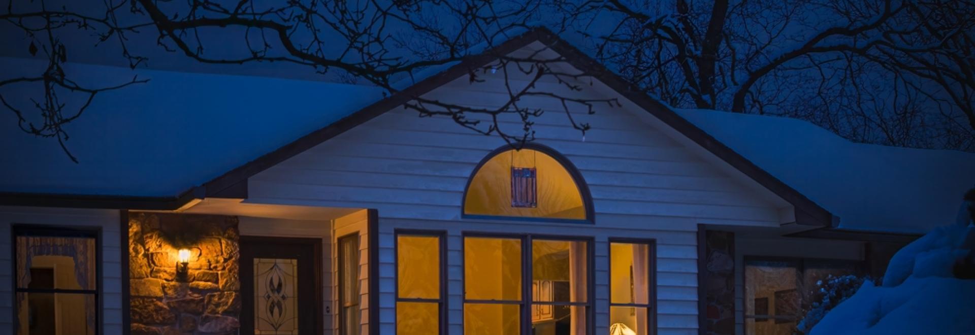 snowy home lit windows