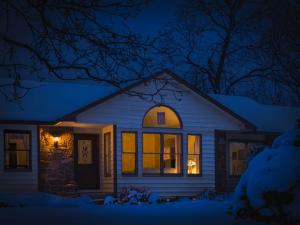 snowy home lit windows